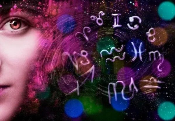 Woman's face with zodiac symbols and colors.