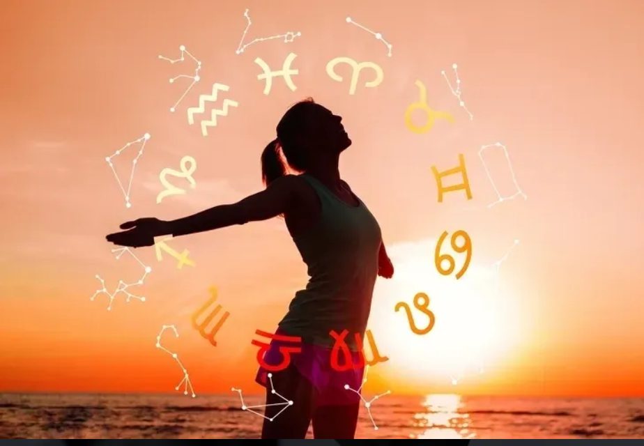 Silhouette woman with zodiac signs at sunset.