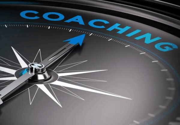 Compass pointing towards "Coaching" in blue letters.