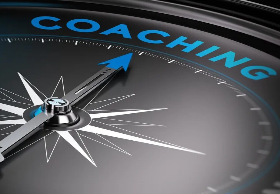 Compass pointing towards "Coaching" in blue letters.