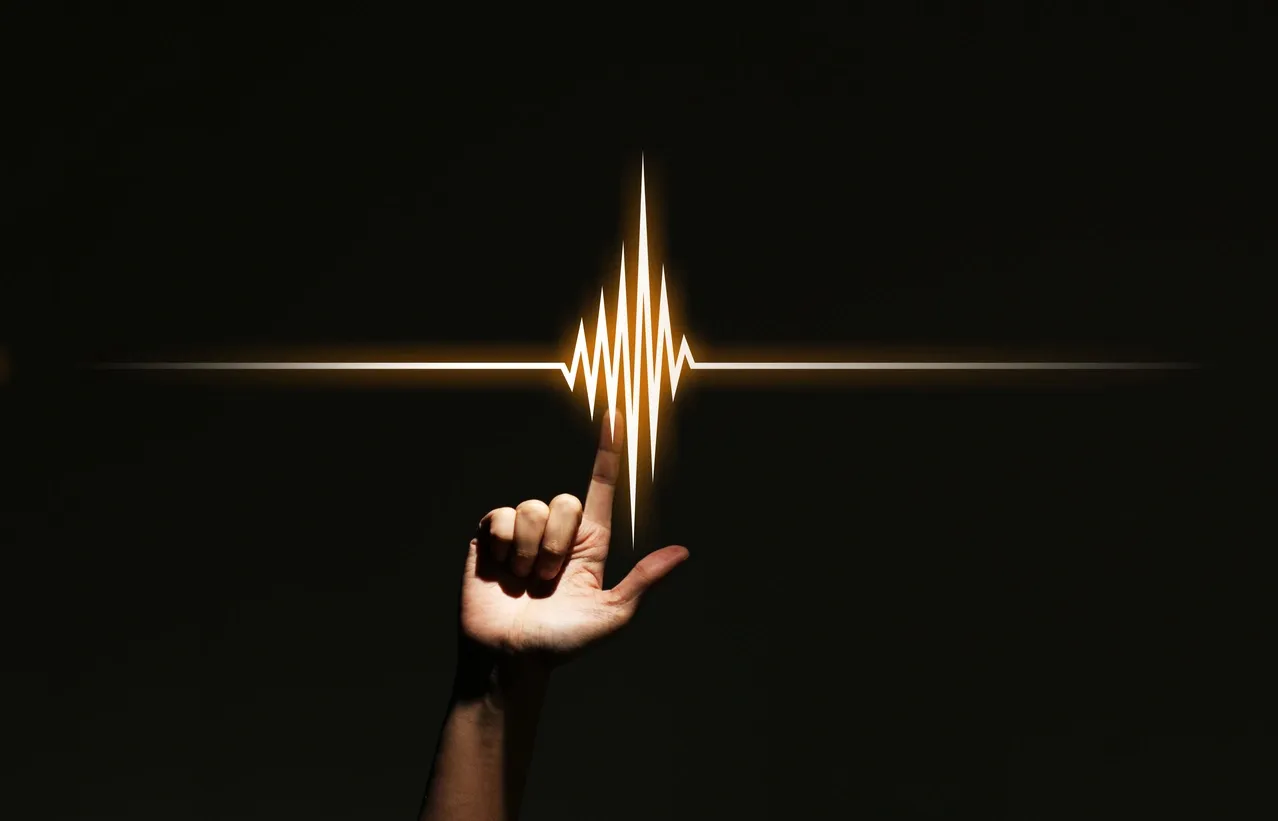 A hand forms an L shape with a glowing heartbeat line above it.