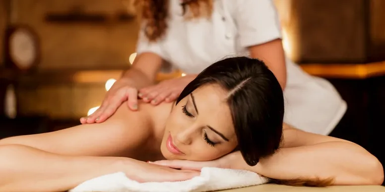 Woman receiving a relaxing shoulder massage.