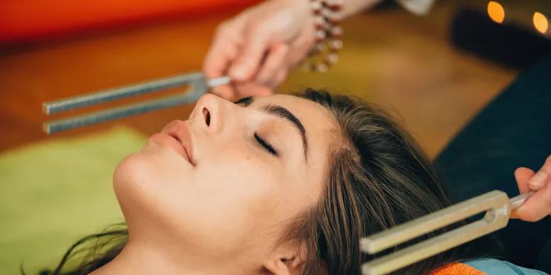 A woman receiving a relaxing facial treatment with closed eyes.