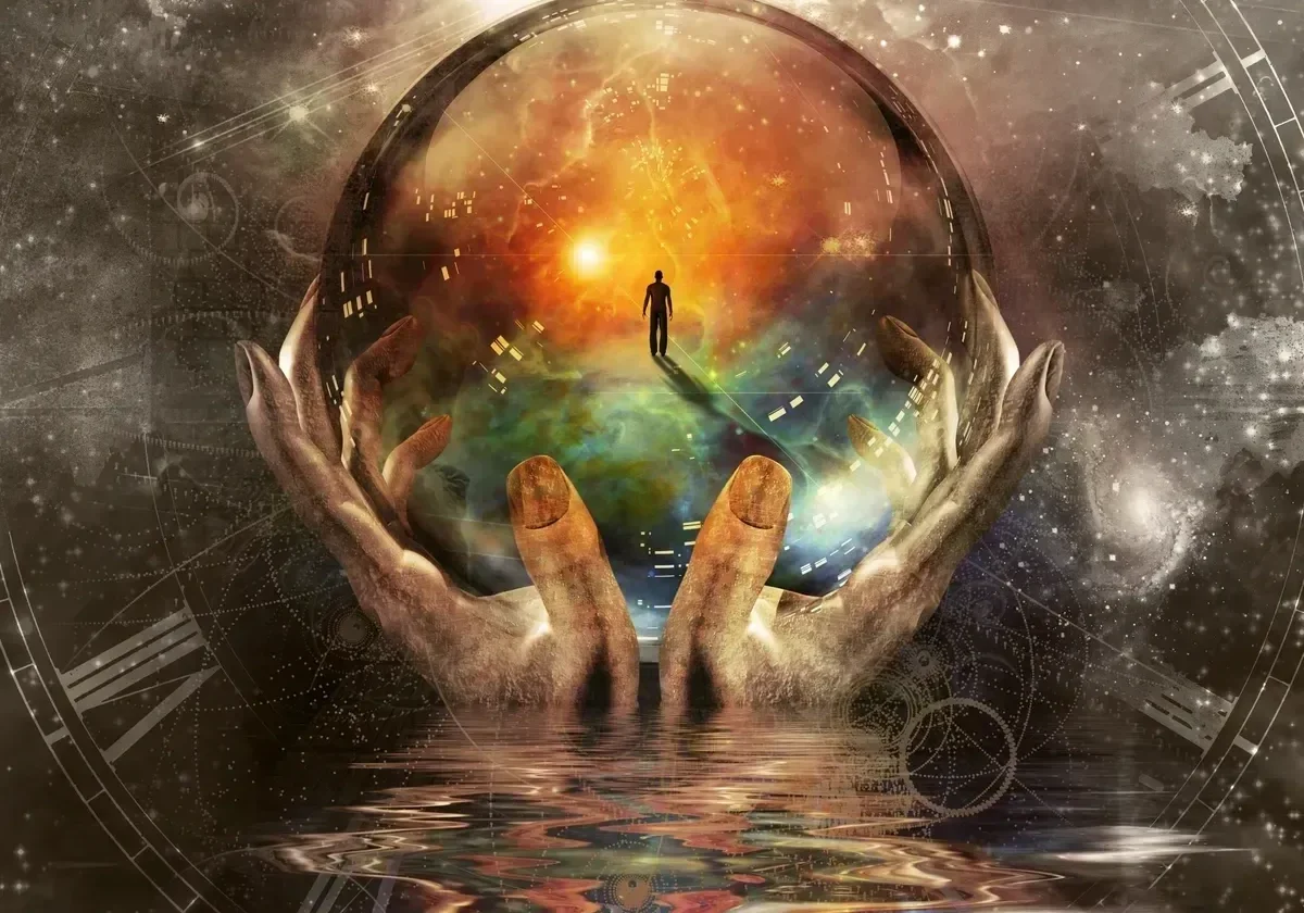 Hands holding a glowing orb with a surreal landscape inside.